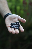 Three BREATHMODE sleep nasal strips held in an outstretched hand 