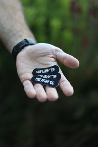 Three BREATHMODE sleep nasal strips held in an outstretched hand 