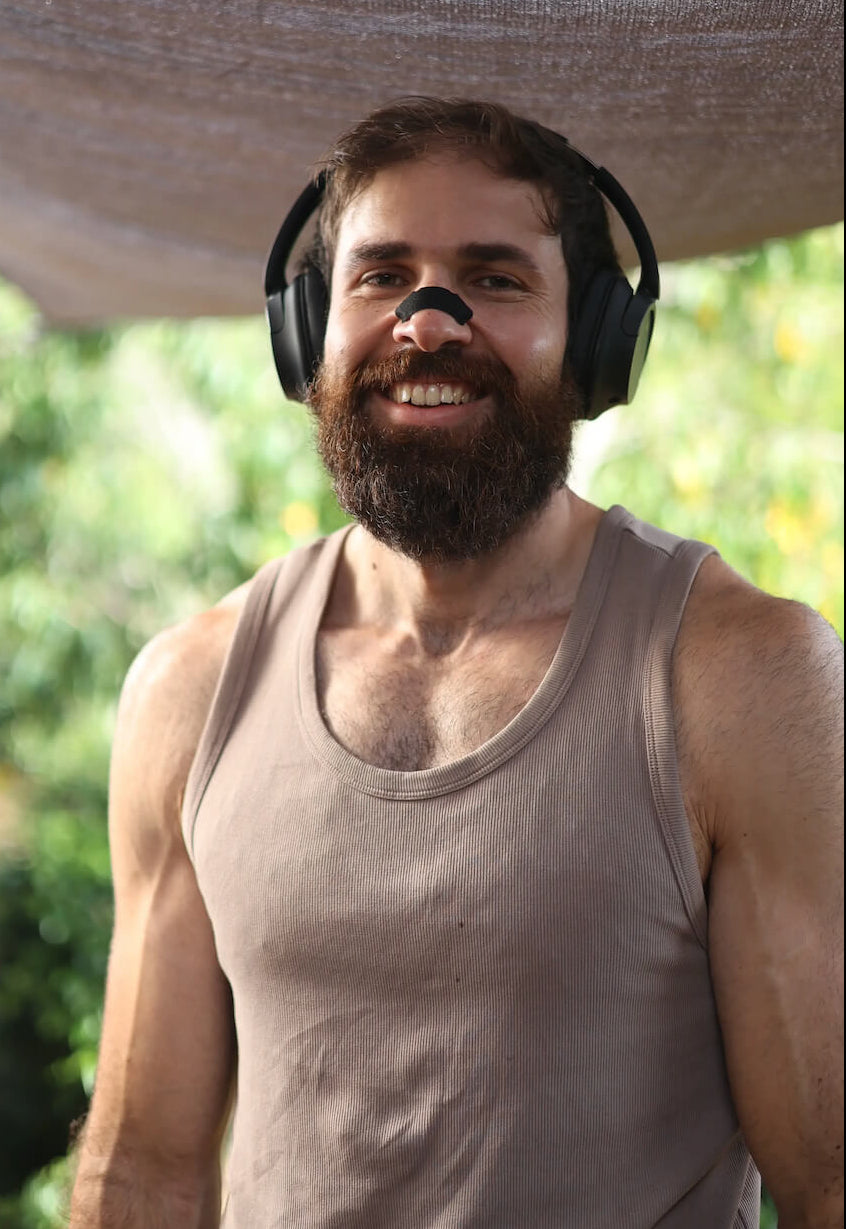 Founder of BREATHMODE Nasal Strips, Jozef Wright smiling and looking at camera while wearing his brands performance nasal strips
